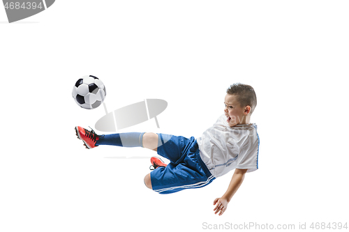 Image of Young boy kicks the soccer ball