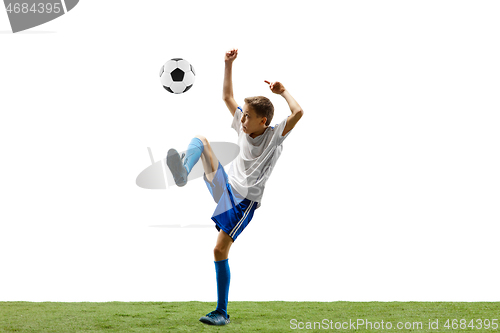 Image of Young boy with soccer ball isolated on white. football player