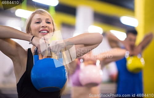 Image of athletes doing exercises with kettlebells