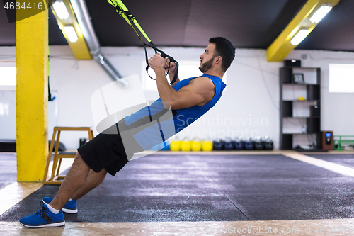 Image of man working out pull ups with gymnastic rings