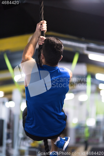 Image of man doing rope climbing