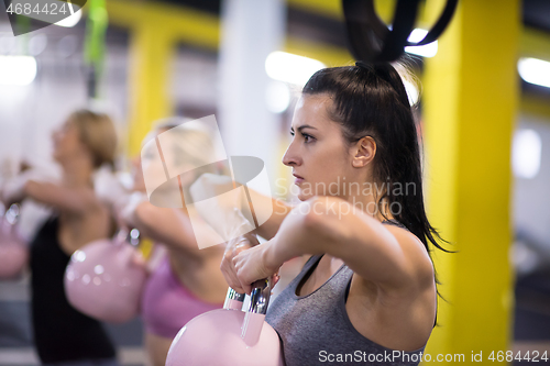 Image of athletes doing exercises with kettlebells