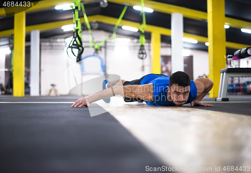 Image of Young  man doing pushups