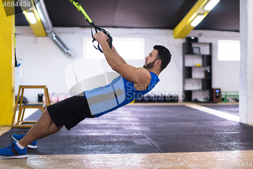 Image of man working out pull ups with gymnastic rings