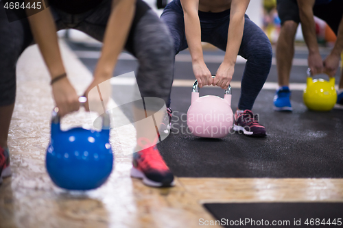 Image of athletes doing exercises with kettlebells