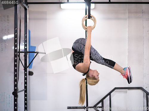 Image of woman working out on gymnastic rings