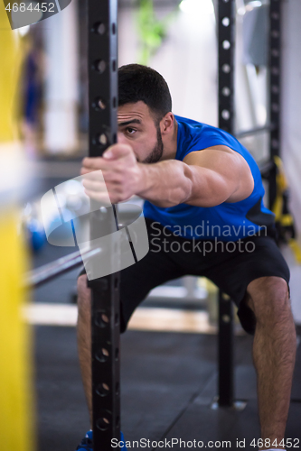 Image of man doing pull ups on the vertical bar