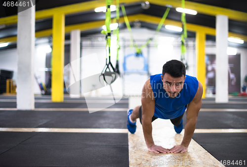 Image of Young  man doing pushups