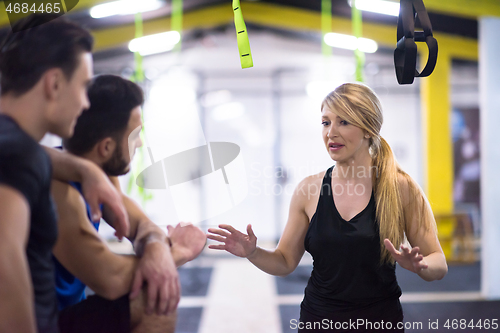 Image of athletes working out  jumping on fit box