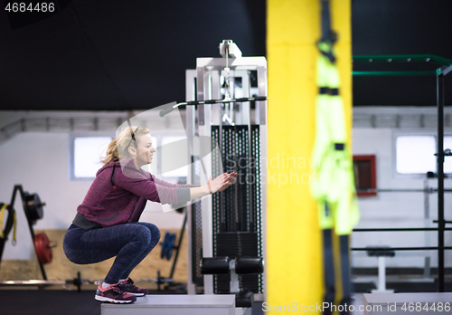 Image of woman working out  jumping on fit box