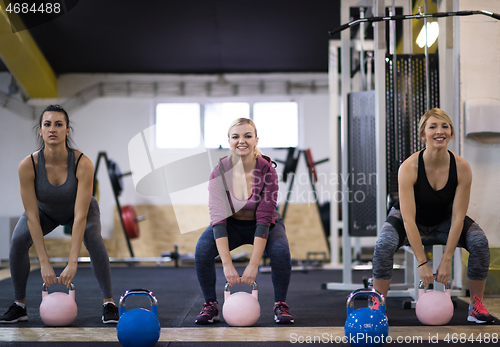 Image of athletes doing exercises with kettlebells