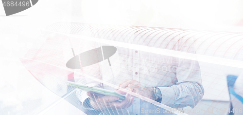 Image of Businessman Using Tablet In Office Building by window