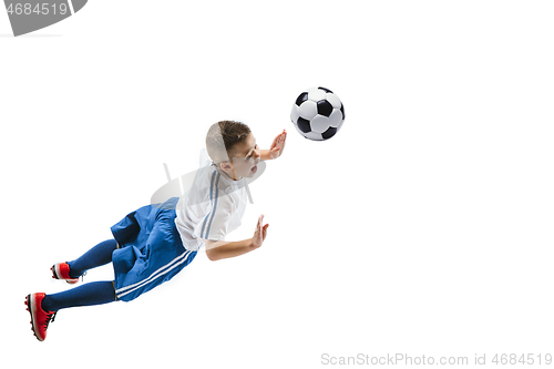 Image of Young boy kicks the soccer ball