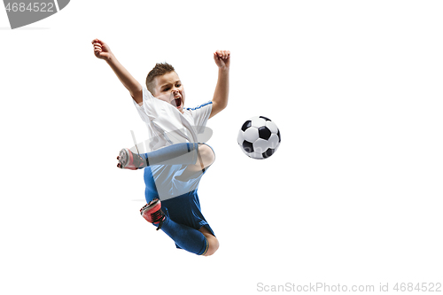 Image of Young boy kicks the soccer ball