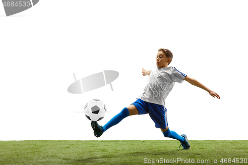 Image of Young boy with soccer ball isolated on white. football player