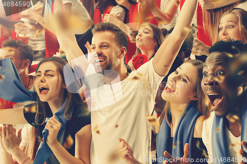 Image of Group of happy fans are cheering for their team victory.