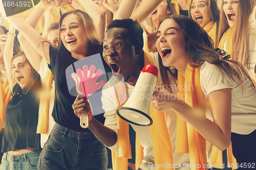 Image of Group of happy fans are cheering for their team victory.