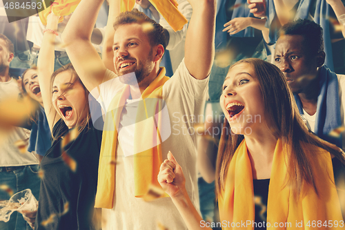 Image of Group of happy fans are cheering for their team victory.