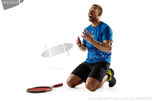 Image of Portrait of a handsome male tennis player celebrating his success isolated on a white background