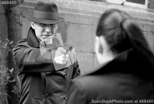 Image of man threatens the woman with a pistol