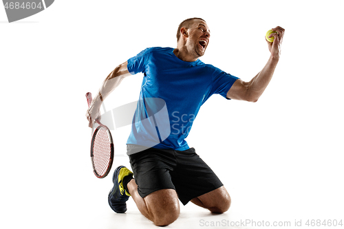 Image of Portrait of a handsome male tennis player celebrating his success isolated on a white background