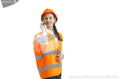 Image of The female builder in orange helmet isolated on white