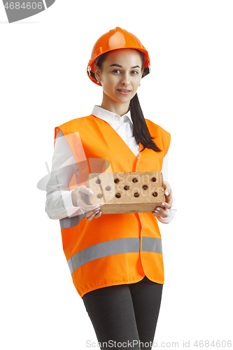 Image of The female builder in orange helmet isolated on white