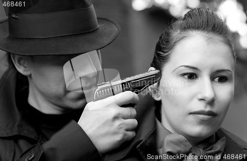 Image of man threatens the woman with a pistol