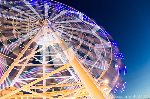 Image of Ferris wheel moving at night