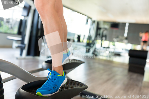 Image of Woman training on Elliptical machine 