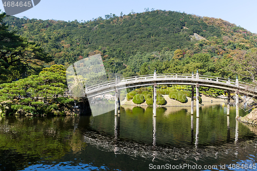 Image of Japanese Ritsurin Garden and wooden bridge