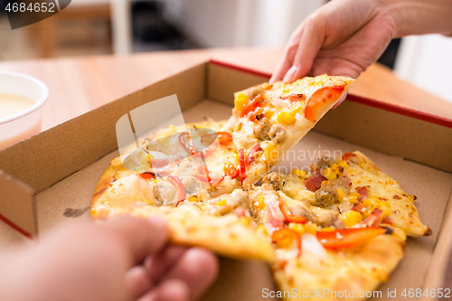 Image of Eating pizza at home