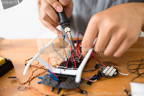 Image of Welding the cable on drone at home