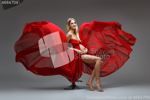 Image of Pregnant girl in red dress