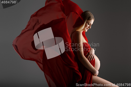 Image of Pregnant girl in red dress