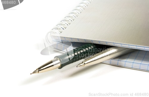 Image of blank notebook and two pens