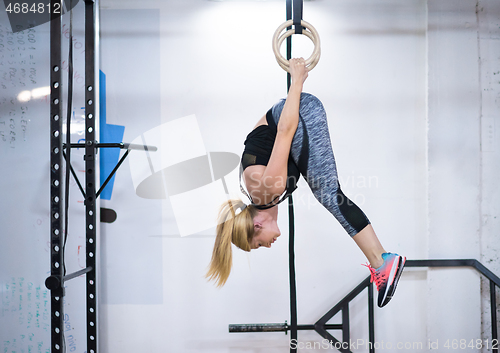 Image of woman working out on gymnastic rings