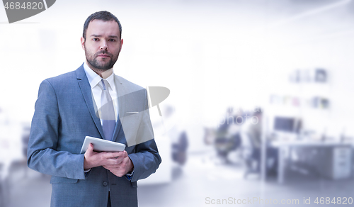 Image of Young businessman in his office