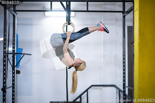 Image of woman working out on gymnastic rings