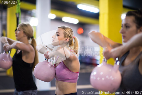 Image of athletes doing exercises with kettlebells