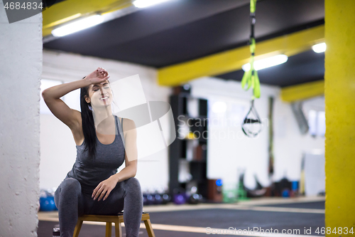 Image of young athlete woman sitting and relaxing