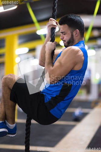 Image of man doing rope climbing