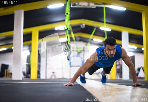 Image of Young  man doing pushups