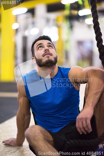 Image of man relaxing before rope climbing