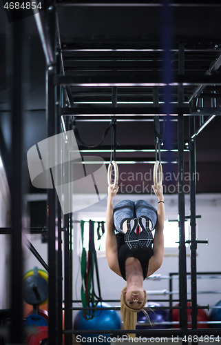 Image of woman working out on gymnastic rings