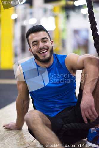 Image of man relaxing before rope climbing