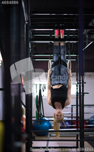 Image of woman working out on gymnastic rings