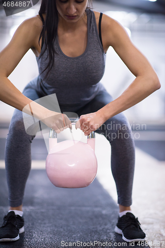 Image of woman exercise with fitness kettlebell