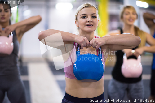 Image of athletes doing exercises with kettlebells