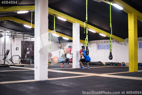 Image of young athletes couple working out with medical ball